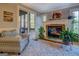 Cozy living room featuring a stone fireplace, large windows, and comfortable seating at 16 Hawkstone Ct, Acworth, GA 30101