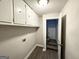 Laundry room with built-in cabinets and stairs to upper level at 2370 Tiffany Cir, Decatur, GA 30035