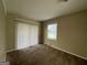 Cozy bedroom with carpet flooring and sliding glass door to patio at 2413 Ben Hill Rd, East Point, GA 30344