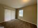 Cozy bedroom with carpet flooring and sliding glass door to patio at 2413 Ben Hill Rd, East Point, GA 30344