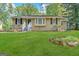 Ranch style home with landscaped yard and a white picket fence at 2413 Ben Hill Rd, East Point, GA 30344
