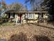 Brick ranch home with a red front door and mature trees at 2413 Ben Hill Rd, East Point, GA 30344