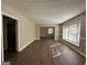 Spacious living room with hardwood floors and large windows at 2413 Ben Hill Rd, East Point, GA 30344