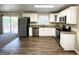 Modern kitchen with white cabinets, stainless steel appliances, and granite countertops at 685 Sheppard Rd, Stone Mountain, GA 30083
