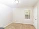Simple bedroom with neutral walls and carpeting, featuring a window and closet at 215 Shadow Wood Dr, Douglasville, GA 30134