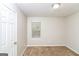 Simple bedroom with neutral walls and carpeting, featuring a window and closet at 215 Shadow Wood Dr, Douglasville, GA 30134