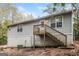 House exterior showcasing rear view, wooden deck and stairs at 215 Shadow Wood Dr, Douglasville, GA 30134