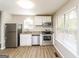Updated kitchen features stainless steel appliances and light wood-look flooring at 215 Shadow Wood Dr, Douglasville, GA 30134