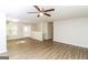 Living room with wood-look floors, ceiling fan and access to hallway at 215 Shadow Wood Dr, Douglasville, GA 30134