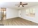 Living room with wood-look floors, ceiling fan and access to hallway at 215 Shadow Wood Dr, Douglasville, GA 30134