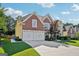 Two-story house with a two-car garage and a well-manicured lawn at 2909 Everson Ridge Ct, Snellville, GA 30039