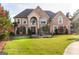 Two-story brick home with fountain and landscaped yard at 957 Fire Thorn Dr, Hampton, GA 30228