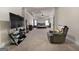 Main bedroom featuring a king-size bed, a ceiling fan, and a small sitting area at 6857 Louis Dr, Locust Grove, GA 30248