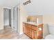Bathroom with wood vanity, toilet and access to other rooms at 32 Peeksville Rd, Locust Grove, GA 30248