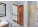 Bathroom with light blue walls, shower, and wood door at 32 Peeksville Rd, Locust Grove, GA 30248