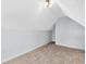 Bonus room with sloped ceilings and neutral decor at 32 Peeksville Rd, Locust Grove, GA 30248