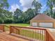 Wooden deck overlooking backyard and detached garage at 32 Peeksville Rd, Locust Grove, GA 30248