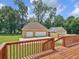 Deck view of backyard, showcasing detached garage at 32 Peeksville Rd, Locust Grove, GA 30248
