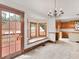 Dining room with hardwood floors, built-in window seat, and access to deck at 32 Peeksville Rd, Locust Grove, GA 30248
