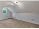 Dormer bedroom with carpet, window, and light fixture at 32 Peeksville Rd, Locust Grove, GA 30248
