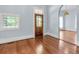 Bright entryway with hardwood floors, stained glass door and window at 32 Peeksville Rd, Locust Grove, GA 30248