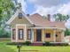 Craftsman style house with a large front porch and mature landscaping at 32 Peeksville Rd, Locust Grove, GA 30248