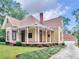 Charming yellow house with wrap-around porch, and a detached garage at 32 Peeksville Rd, Locust Grove, GA 30248