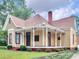 Beautiful yellow house with wrap-around porch and red trim at 32 Peeksville Rd, Locust Grove, GA 30248