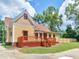 Charming yellow house with a deck and fenced yard at 32 Peeksville Rd, Locust Grove, GA 30248