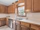 Bright kitchen with wood cabinets, stainless steel appliances, and a window above the sink at 32 Peeksville Rd, Locust Grove, GA 30248