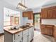 Bright kitchen with island, wood cabinets, and access to backyard at 32 Peeksville Rd, Locust Grove, GA 30248