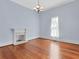 Bright living room with hardwood floors, fireplace, and large window at 32 Peeksville Rd, Locust Grove, GA 30248