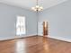 Living room with hardwood floors, chandelier, and view of bathroom at 32 Peeksville Rd, Locust Grove, GA 30248