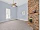 Living room featuring a brick fireplace and window at 32 Peeksville Rd, Locust Grove, GA 30248
