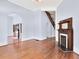 Spacious living room featuring hardwood floors, a fireplace, and an arched doorway at 32 Peeksville Rd, Locust Grove, GA 30248