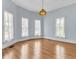 Sunlit living room with hardwood floors and chandelier at 32 Peeksville Rd, Locust Grove, GA 30248