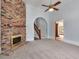 Living room featuring a brick fireplace and arched hallway at 32 Peeksville Rd, Locust Grove, GA 30248