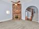 Living room with brick fireplace and view of staircase at 32 Peeksville Rd, Locust Grove, GA 30248