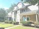 Two-story townhome with gray siding, teal door, and manicured landscaping at 6390 Arbor Ln, Morrow, GA 30260