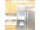 Kitchen with stainless steel refrigerator and wood cabinets at 6390 Arbor Ln, Morrow, GA 30260