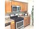 Kitchen with wood cabinets, stainless steel appliances, and granite countertops at 6390 Arbor Ln, Morrow, GA 30260