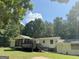 Home features a screened porch and deck overlooking a wooded area at 628 Bexton Rd, Moreland, GA 30259