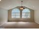 Spacious bedroom with vaulted ceiling, carpeting, and two arched windows at 628 Bexton Rd, Moreland, GA 30259