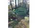 Detached green garage in the backyard at 1521 Green Valley Ct, Conley, GA 30288