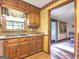 Kitchen features wood cabinets, granite countertops, and a window at 2021 Brook Valley Ct, Jonesboro, GA 30236