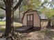 Tan shed with double doors in the backyard at 2021 Brook Valley Ct, Jonesboro, GA 30236
