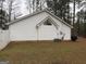 Back exterior view of a single-story home with a small grassy backyard at 116 Winthrop Dr, Sharpsburg, GA 30277