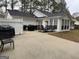 Spacious backyard with a patio, sunroom, grill, and white fence at 116 Winthrop Dr, Sharpsburg, GA 30277