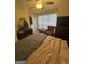 Spacious bedroom with sitting area, ceiling fan, and natural light at 116 Winthrop Dr, Sharpsburg, GA 30277