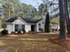 Charming single-story home with a landscaped front yard and trees at 116 Winthrop Dr, Sharpsburg, GA 30277